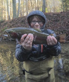 Child with big smile holding big trout
